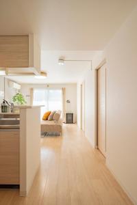 a kitchen and a living room with a couch at La Meridian Atsubetsu 401 in Sapporo