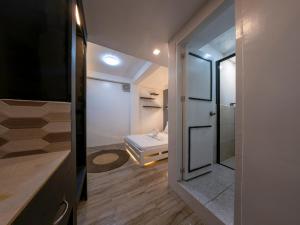 a bathroom with a walk in shower and a mirror at Sip Sunset Hostel and Lounge in El Nido +120 photos