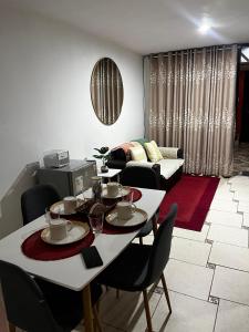 a living room with a white table and chairs at Palmeras house in Ica