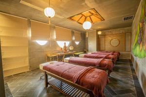 a row of beds in a room with wooden walls at MissBamboo Hotel Nha Trang in Nha Trang +64 photos