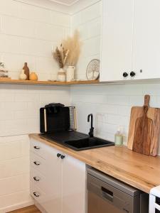 a kitchen with a sink and a counter top at Family & Couples Beachside Stay Ocean Glimpses 7 day Xmas 2026 available in Brooms Head +42 photos