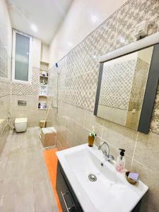 a bathroom with a sink and a toilet and a mirror at Dar D'Art in Tunis