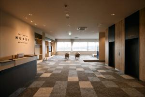 a lobby with a checkered floor in a building at COZY HOTEL NUKUI shimanami in Imabari +115 photos