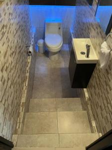 a bathroom with a toilet and a sink at Rey 179 in Morelia