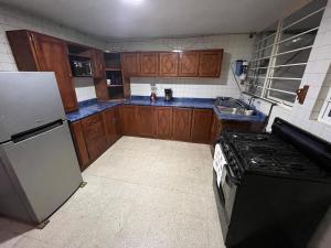 a small kitchen with a stove and a refrigerator at Rey 179 in Morelia