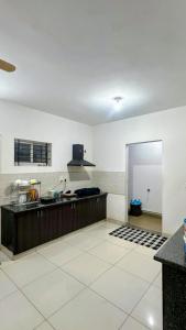 a large kitchen with a counter and a counter top at Simba Stay's 2BHK 1 in Chikmagalūr