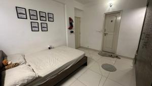 a small bedroom with a bed and a tiled floor at Simba Stay's 2BHK 1 in Chikmagalūr +2 photos