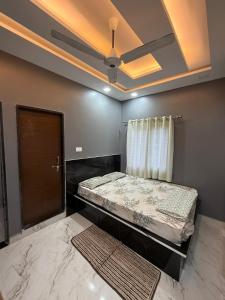 a bedroom with a bed and a ceiling at Simba Stay's 2BHK 1 in Chikmagalūr