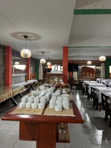 a dining room with a table with tea jars on it at Hotel Ciconha in São Lourenço
