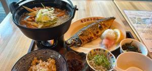 a table with a plate of food on a table at hotel gala city Izumizaki 5 mins to Kokusai Street 24 square meters room in Naha