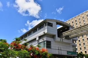 a building with a blue sky in the background at hotel gala city Izumizaki 5 mins to Kokusai Street 24 square meters room in Naha