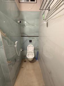 a small bathroom with a toilet in a stall at Simba Stay's 2BHK in Chikmagalūr +5 photos