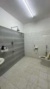 a bathroom with a toilet and a sink at Simba Stay's 2BHK in Chikmagalūr