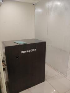 a black box with a registration sign on it in a room at Royal Inn in Mysore