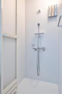 a shower in a bathroom with a glass door at Tsubaki in Otsu +67 photos
