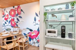 a kitchen with a table and a microwave at Tsubaki in Otsu