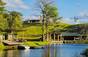 a house with a dock and a boat on a lake at Loma Linda in Arenal