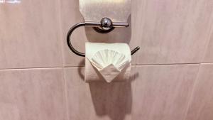 a roll of toilet paper on a wall in a bathroom at Kamala Garden Bungalows in Kamala Beach +33 photos