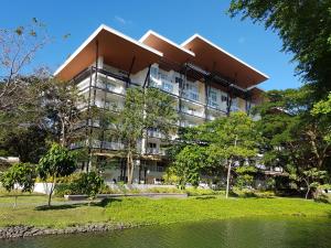 an apartment building with a pond in front of it at Myna Lagoon Pico de Loro in Nasugbu