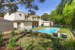 a house with a swimming pool in a yard at Villa Syrene Pool and Spa Retreat in Rye