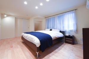 a bedroom with a large bed and a window at Luxury New House in Tokyo