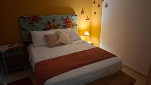 a bed with two pillows on it in a room at Costamar Galinhos in Galinhos