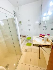 a bathroom with a shower and a sink at Pousada ExpoBH in Belo Horizonte +15 photos