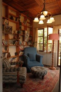 a living room with a blue chair and a lamp at SIA Home in Da Lat