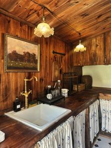 a bathroom with a large tub in a wooden wall at SIA Home in Da Lat +125 photos