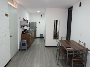 a room with a desk and a kitchen with a table at Depa Risalud! in Santa Cruz Huatulco