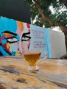 a cup of tea sitting on a wooden table at Kochi Bella Villa in Cochin