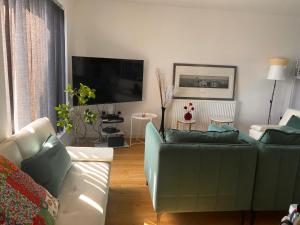a living room with a couch and a flat screen tv at Amani Sanctuary 2 Bedroom House in Sherburn Hill +12 photos