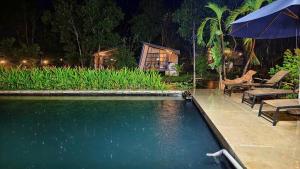 a swimming pool in a backyard at night at Homestay in Nhơn Trạch