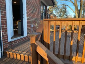 a wooden deck with a bench on a house at Flower Avenue Hosting - Private Suite with De Luxe King Size Bed - 77 per Night 1st guest - 59 2nd guest - 52 each third & 4th guests in Silver Spring