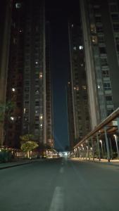 an empty city street at night with tall buildings at Staycation Couple friendly House in Thane