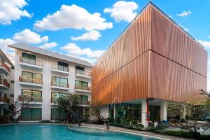 an external view of a building with a pool at After Rain Hotel in Chiang Mai
