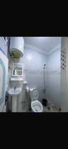 a bathroom with a toilet and a sink at Casa Sharawy in Chefchaouen