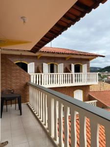 a balcony with a view of a house at Hotel Ciconha in São Lourenço