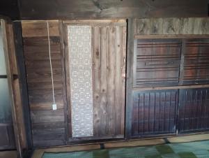 a room with wooden doors and a window at Hostel 53 in Tuyama +27 photos