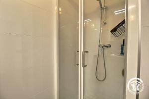a shower with a glass door in a bathroom at Le randonneur in Pleubian +12 photos