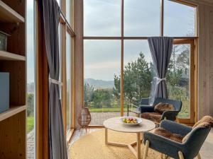 a room with a table and chairs and a large window at Architect's House With Panoramic View In Lumsås in Lumsås