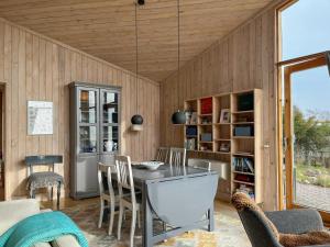 a kitchen with a table and chairs in a room at Architect's House With Panoramic View In Lumsås in Lumsås