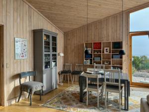a dining room with a table and chairs at Architect's House With Panoramic View In Lumsås in Lumsås +30 photos
