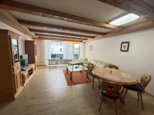 a living room with a table and a couch at Karwendel Lodge in Mittenwald