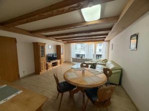 a living room with a table and a couch at Karwendel Lodge in Mittenwald +17 photos