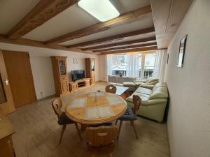 a living room with a table and a couch at Karwendel Lodge in Mittenwald