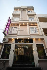 a large white building with a sign on it at Hotel Mantra Inn in Haridwār