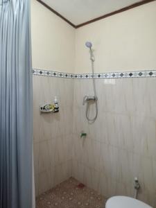 a bathroom with a shower and a toilet in it at pondok tegal jero in Jatiluwih +11 photos