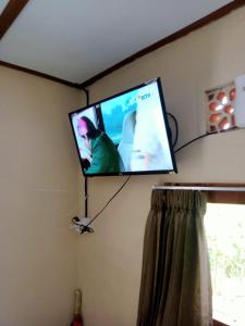 a flat screen tv hanging on a wall at pondok tegal jero in Jatiluwih