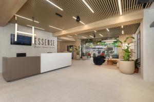 an office lobby with a reception desk and potted plants at Essense Baltic Resort & SPA in Dziwnów +196 photos